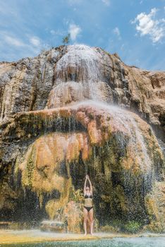 one woman bathing at ma'in hot springs waterfall in Jordan middle east