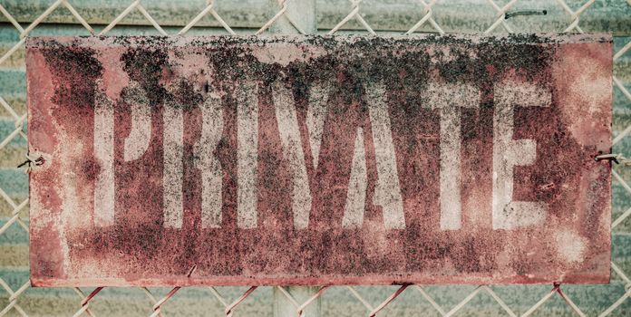 Retro Filtered Photo Of Rusty Grungy Old Private Property Sign On Chain Link Fence