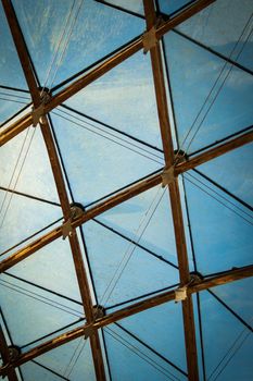 A detail photo of a transparent glass ceiling with repeating triangle and diamond shaped frame.