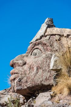 Inca face sculpture in the peruvian Andes at Puno Peru