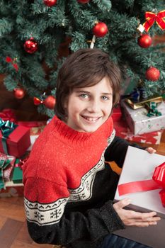 10-12, beside, box, boy, camera, caucasian, celebration, child, childhood, christmas, christmastime, claus, cute, event, eyes, floor, gift, giftbox, green, handsome, happiness, holiday, kid, look, looking, merry, model, new, occasion, old, people, person, present, property, releases, santa, sitting, smile, smiling, son, surprise, tree, x-mas, xmas, year, years, youngster
