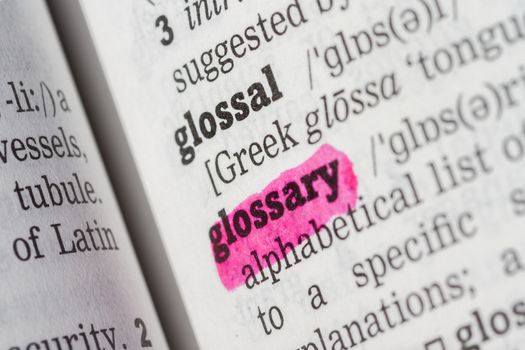 Glossary highlighted in dictionary with pen closeup