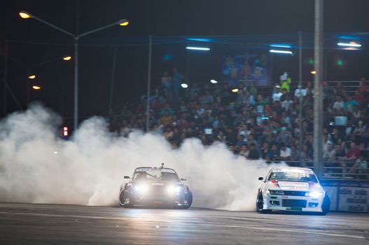 PATTAYA - NOVEMBER 30: Two competitors participating in Thailand Drift Series 2014 at Chayapruek, in Pattaya, Thailand on November 30, 2014.