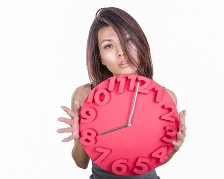 Chinese woman looking tired holding clock showing eight o' clock; conceptual late for work or meeting