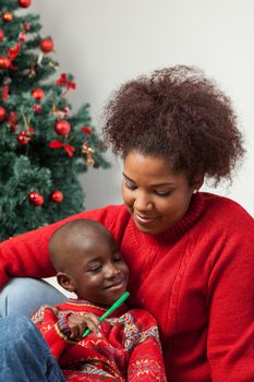 30-35, 4-6, beautiful, black, bookmark, boy, celebration, cheerful, child, childhood, christmas, color, cute, decoration, family, fun, hand, happiness, happy, holding, infant, kid, little, love, man, model, mother, occasion, old, parent, person, portrait, property, red, releases, room, smile, smiling, son, tree, vertical, woman, x-mas, xmas, years