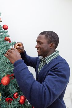 30-35, adult, african, background, balls, beautiful, black, celebration, cheerful, child, christmas, cute, decoration, festive, festivity, handsome, happy, home, homey, indoors, joyful, lifestyle, living, male, man, model, old, one, person, portrait, property, red, releases, room, smiling, time, tree, vertical, white, xmas, years