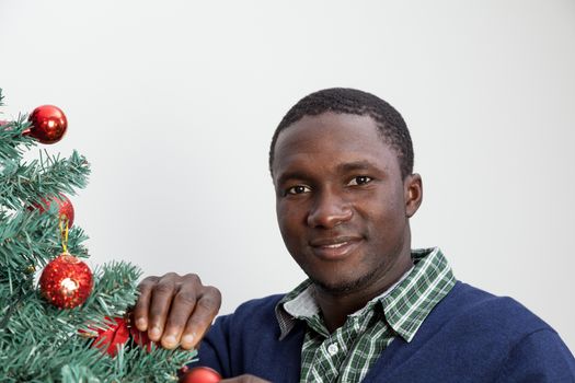 30-35, adult, african, background, balls, beautiful, black, celebration, cheerful, child, christmas, couple, cute, decoration, festive, festivity, handsome, happy, home, house, household, husband, joyful, living, love, male, man, model, old, person, portrait, property, releases, room, smile, smiling, tree, two, vertical, white, wife, xmas, years