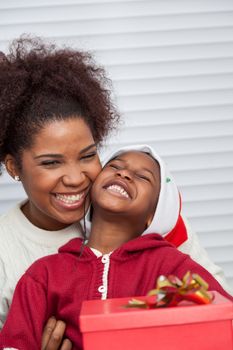 30-35, 4-6, african, apartment, background, beautiful, black, celebration, cheerful, child, christmas, cute, dad, family, father, gift, hair, happiness, happy, hat, home, homey, house, kid, leisure, life, living, model, old, parent, person, portrait, pretty, property, red, releases, room, sitting, smile, smiling, son, together, two, vertical, xmas, years, young