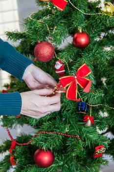 30-35, adult, balls, beautiful, caucasian, celebrate, christmas, claus, cute, december, decor, decorating, decorations, event, female, festive, garland, green, hands, holding, home, indoors, joy, livingroom, merry, model, old, ornament, people, person, pretty, property, red, releases, room, santa, sweater, topknot, tradition, traditional, tree, vertical, winter, woman, xmas, years, young