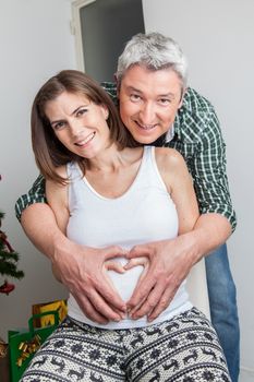 35-40, at, awaiting, belly, camera, charming, cheerful, christmas, couple, cute, dad, daddy, expecting, family, father, female, gift, hand, happiness, happy, holding, joy, laughing, life, looking, love, man, maternal, maternity, merry, model, mom, mother, motherhood, old, parenthood, pregnancy, pregnant, property, release, smiling, tree, vertical, white, woman, x-mas, xmas, years, caucasian
