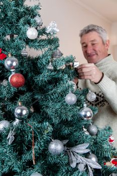 35-40, adult, at, ball, balls, camera, caucasian, celebration, christmas, cute, decorating, decoration, decorations, family, father, festive, fun, green, handsome, happiness, happy, holiday, home, house, looking, love, male, man, model, old, person, pine, property, release, smile, smiling, tradition, traditional, tree, vertical, white, x-mas, xmas, years