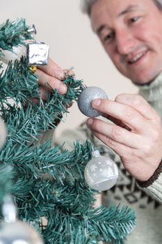 35-40, adult, artificial, background, balls, branches, caucasian, celebration, christmas, decorating, decorations, festive, focus, garland, green, hands, handsome, happy, holiday, male, man, model, old, ornaments, person, pine, pleasure, property, red, releases, santa, seasonal, smiling, tall, tradition, tree, vertical, white, xmas, years, young