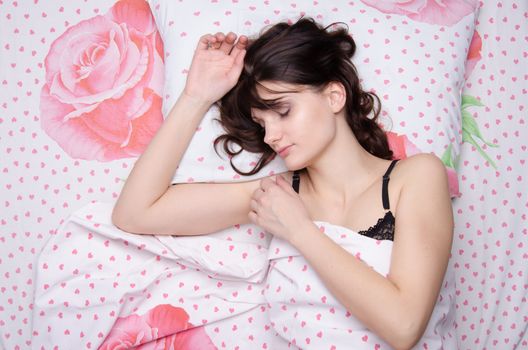 The young beautiful woman sleeping in bed