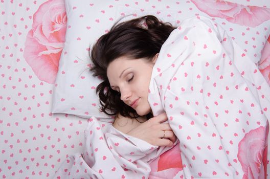 The young beautiful woman sleeping in bed