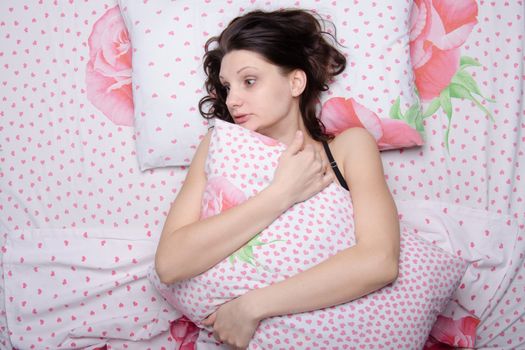 Young beautiful girl sleeping alone in bed