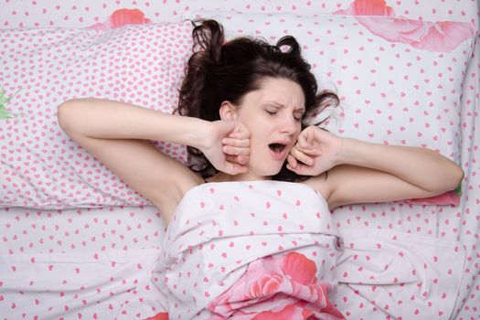 Young beautiful girl woke up alone in bed
