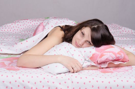 Beautiful young girl lying in the bed