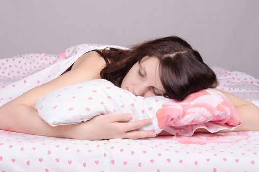 Beautiful young girl lying in the bed