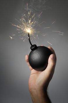Man throwing an old-style (fake) bomb.