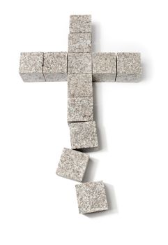Broken christian cross made of granite blocks