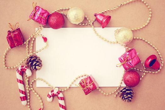 Christmas holiday background with blank greeting card and Christmas decorations, retro filter effect