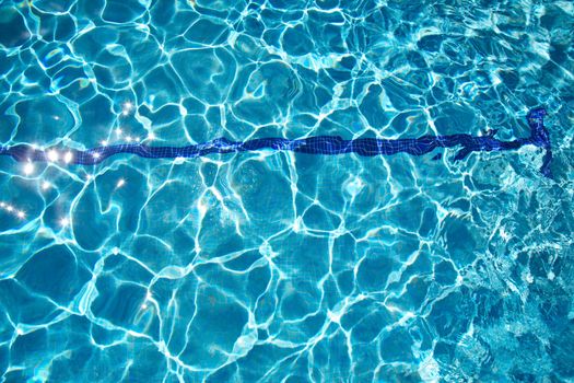 bottom of swimming pool with blue transparent water