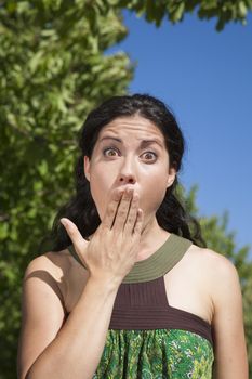 hand on mouth surprising woman in exterior background