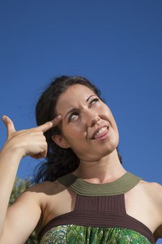 woman gesticulating crazy finger symbol in head