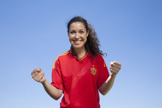 woman with spanish soccer team shirt cheering happy