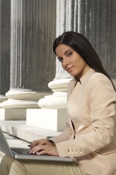 pretty brunette businesswoman typing in laptop
