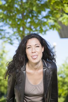 brunette woman teasing at exterior background