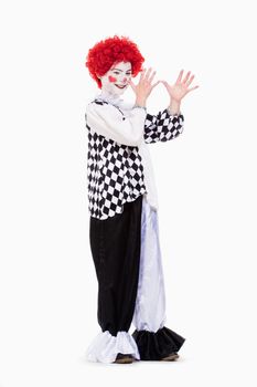 Little Girl in Red Wig, Makeup and Outfit Posing as a Clown.
