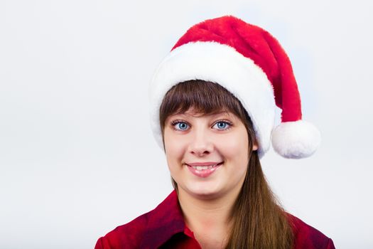 Young blue-eyed beautiful girl in santa hat