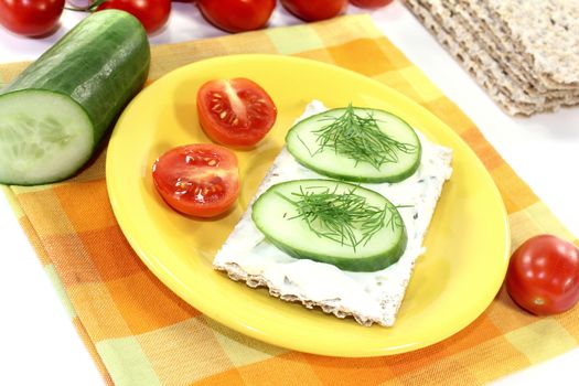 Crispbread with cream cheese on a bright background