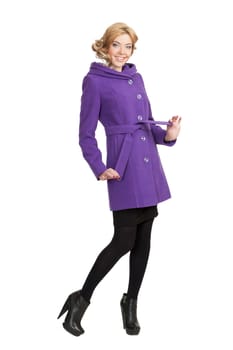 The girl in a violet autumn coat on a white background