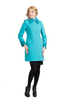 The girl in a turquoise autumn coat on a white background