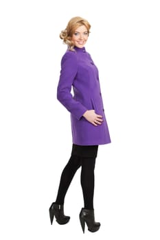 The girl in a violet autumn coat on a white background