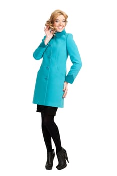 The girl in a turquoise autumn coat on a white background