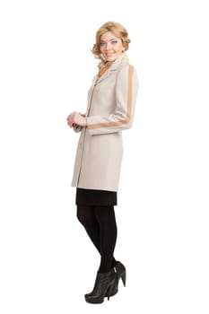 The girl in a white autumn coat on a white background