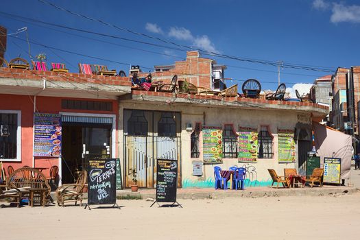 COPACABANA, BOLIVIA - OCTOBER 19, 2014: The restaurants Cuzco Rumi and Winay Marka on the corner of the avenues 6 de Agosto and Costanera along the shore of Lake Titicaca in the small tourist town on October 19, 2014 in Copacabana, Bolivia
