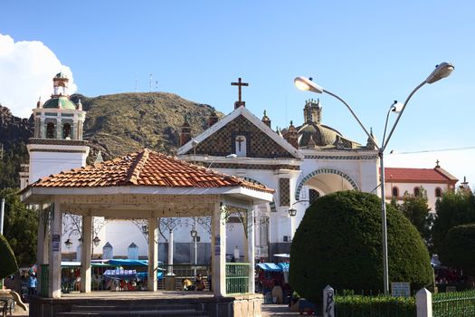 COPACABANA, BOLIVIA - OCTOBER 19, 2014: Pavillon on the Plaza 2 de Febrero (main square) wih the Basilica of Our Lady of Copacabana behind in the small tourist town along Lake Titicaca on October 19, 2014 in Copacabana, Bolivia. 