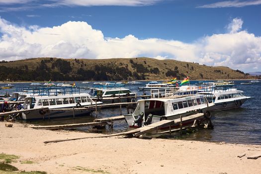 COPACABANA, BOLIVIA - OCTOBER 28, 2014: Many tour boats in the harbor of the small tourist town of Copacabana in a bay of Lake Titicaca on October 28, 2014 in Copacabana, Bolivia. Boats to the popular travel destination of Isla del Sol go from here daily.  