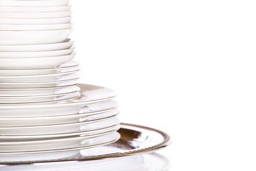 Stack of white dishes on silver platter