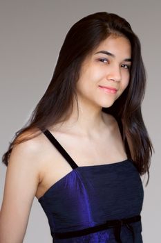 Beautiful biracial teen girl wearing purple gown