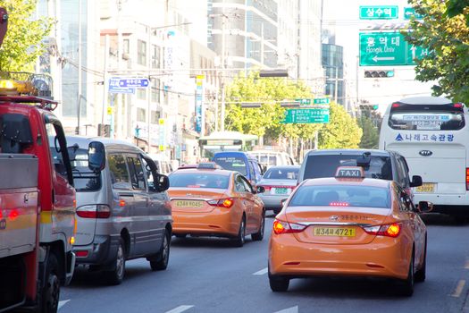 Seoul, Republic of Korea - November 4, 2014: Traffic approaching on a busy road through the Gangnam district on November 4, 2014 in seoul, Gangnam is an affluent district in Seoul, South Korea.