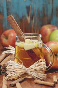 Wassail Punch.  Winter drink with apples and spices on rustic wood. . A macro photograph with shallow depth of field. Done with vintage retro filter.