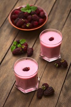 Freshly prepared blackberry milkshake in two glasses (Selective Focus, Focus on the blackberry on the first milkshake)