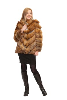 The blue-eyed blonde in a magnificent fur coat, it is isolated on a white background