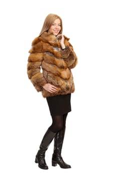 The blue-eyed blonde in a magnificent fur coat, it is isolated on a white background