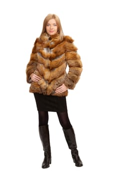 The blue-eyed blonde in a magnificent fur coat, it is isolated on a white background